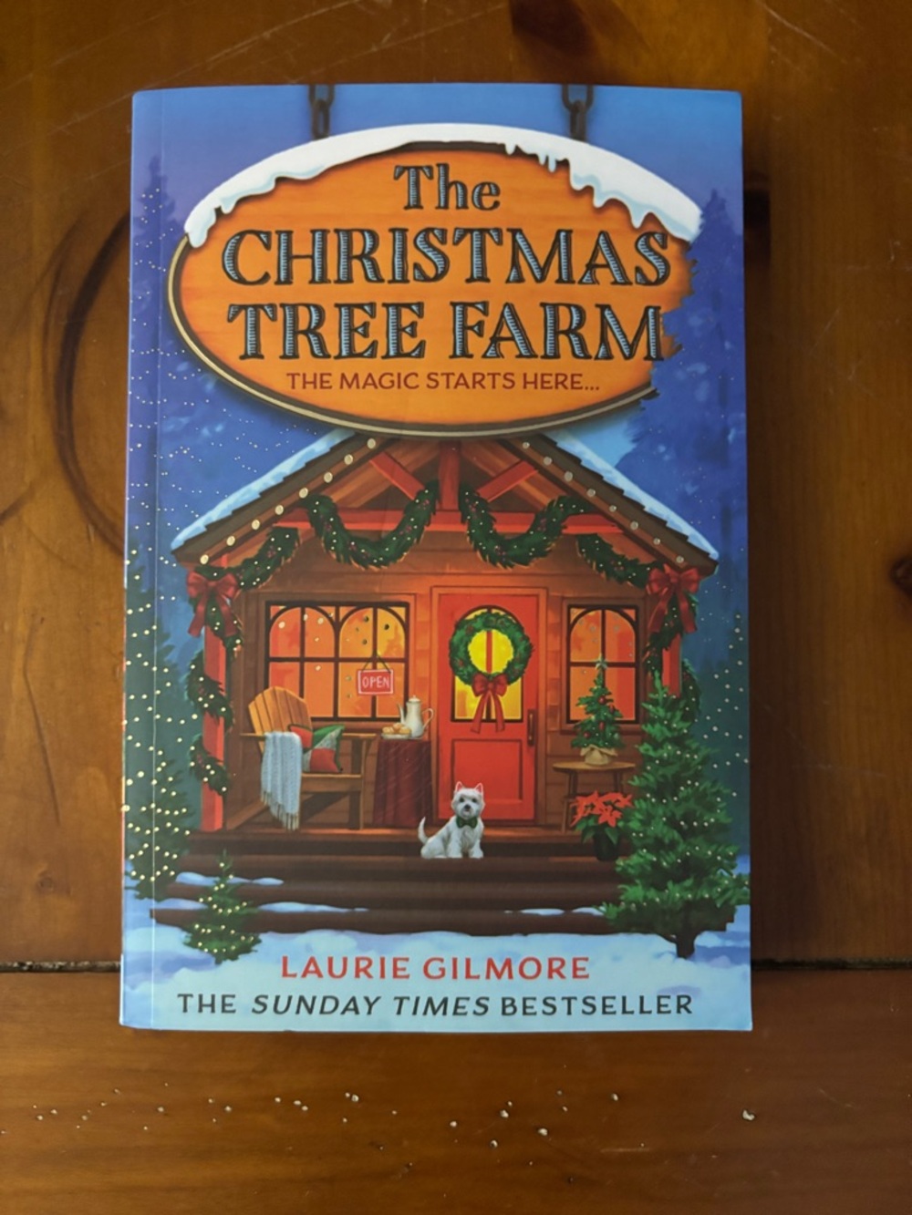 The Christmas Tree Farm by Laurie Gilmore - Blue/Red Illustrated Paperback.